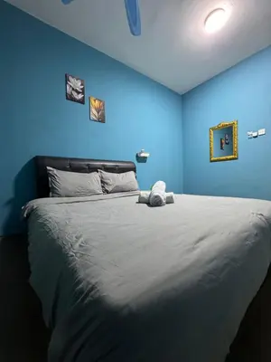 a blue bedroom with a large bed with blue walls at cozy,Bayan,lepas 4pax1car ParkSpiceAirPort domestic guest only in Bayan Lepas