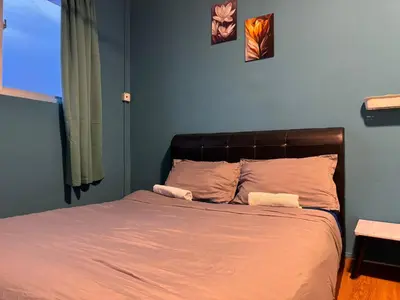 a bed with two towels on it in a bedroom at cozy,Bayan,lepas 4pax1car ParkSpiceAirPort domestic guest only in Bayan Lepas