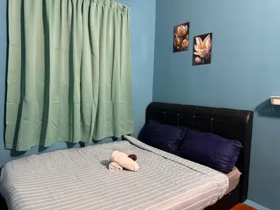 a teddy bear laying on a bed in a bedroom at cozy,Bayan,lepas 4pax1car ParkSpiceAirPort domestic guest only in Bayan Lepas