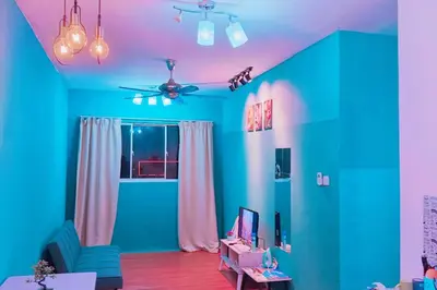 a living room with blue and green walls at cozy,Bayan,lepas 4pax1car ParkSpiceAirPort domestic guest only in Bayan Lepas