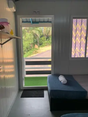 a room with a bed and a large window at Farhani Cabin Stay in Kampong Batu Lima