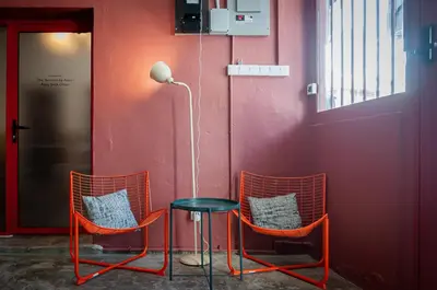 three chairs and a table in a room at The Terraces by Aayu - 2 mins walk to Chulia Street in George Town