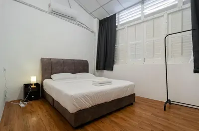 a bedroom with a bed and a window at The Terraces by Aayu - 2 mins walk to Chulia Street in George Town