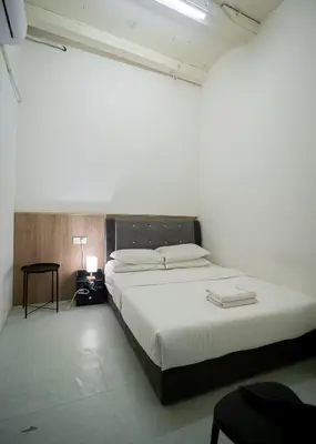 a bedroom with a large white bed in a room at The Terraces by Aayu - 2 mins walk to Chulia Street in George Town
