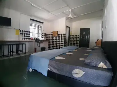 a bedroom with a large bed in a room at Mukhriz 2 Roomstay in Kulim