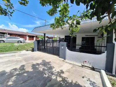 a white house with a gate in front of it at Mukhriz 2 Roomstay in Kulim