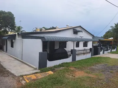 a small white house with a black fence at Mukhriz 2 Roomstay in Kulim