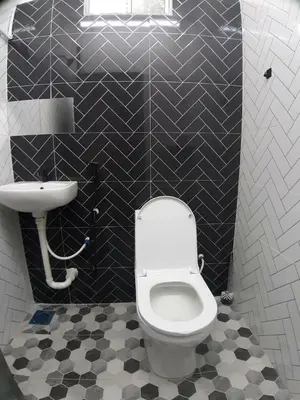 a bathroom with a white toilet and a sink at Mukhriz 2 Roomstay in Kulim