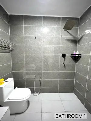 a bathroom with a toilet and a shower stall at SFS Family Homestay Kulim in Kulim