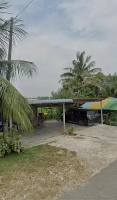 a gas station with a truck parked under a roof at SFS Family Homestay Kulim in Kulim