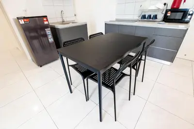 a black table and chairs in a kitchen at The Sun Executive #BayanLepas #QueensbayMall #8 in Bayan Lepas