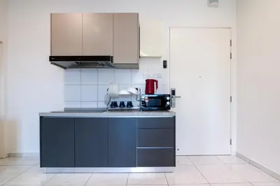 a kitchen with a black counter top and a appliance at The Sun Executive #BayanLepas #QueensbayMall #8 in Bayan Lepas