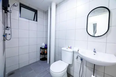 a bathroom with a toilet and a sink and a mirror at The Sun Executive #BayanLepas #QueensbayMall #13 in Bayan Lepas