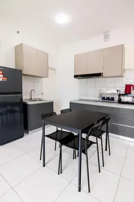 a kitchen with a black table and chairs at The Sun Executive #BayanLepas #QueensbayMall #13 in Bayan Lepas