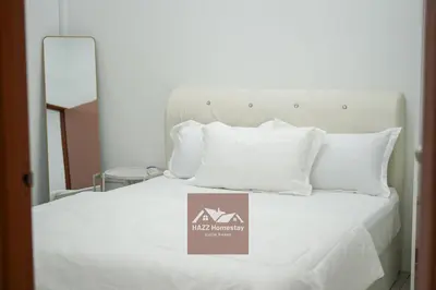 a white bed with a sign on top of it at HAZZ Homestay Puncak Ihsan in Kulim