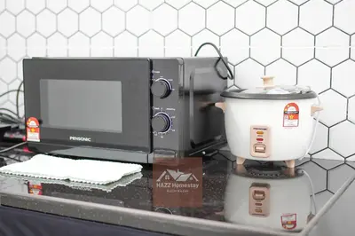 a kitchen counter with a microwave and a mixer at HAZZ Homestay Puncak Ihsan in Kulim