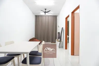 a dining room with a white table and blue chairs at HAZZ Homestay Puncak Ihsan in Kulim