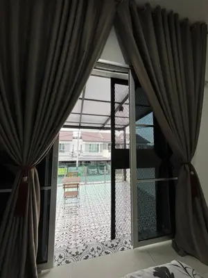 a bedroom with a window with a view of a patio at KN Homestay in Butterworth