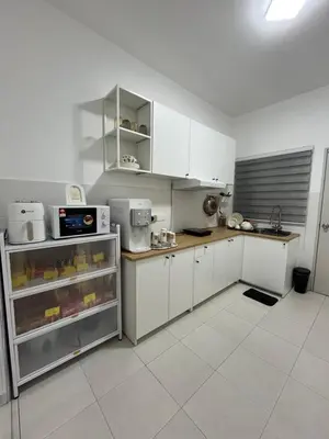 a kitchen with white cabinets and white appliances at KN Homestay in Butterworth