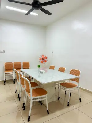 a dining room with a white table and chairs at Happy Guest House Nibong Tebal \u5f00\u5fc3\u6c11\u5bbf\u9ad8\u6e0a\u533a in Nibung Tebal