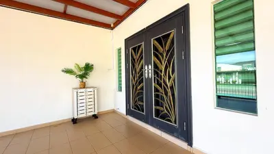 a door on a house with a plant on it at Happy Guest House Nibong Tebal \u5f00\u5fc3\u6c11\u5bbf\u9ad8\u6e0a\u533a in Nibung Tebal