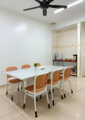 a dining room with a white table and chairs at Happy Guest House Nibong Tebal \u5f00\u5fc3\u6c11\u5bbf\u9ad8\u6e0a\u533a in Nibung Tebal