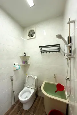 a bathroom with a toilet and a bath tub at Happy Guest House Nibong Tebal \u5f00\u5fc3\u6c11\u5bbf\u9ad8\u6e0a\u533a in Nibung Tebal