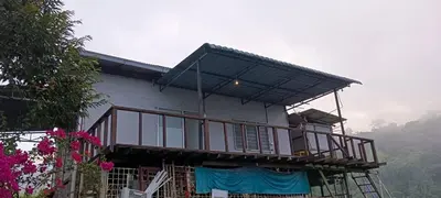 a house with a balcony on top of it at Bukit Limau rest house Merbau in Taiping