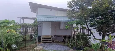 a small white house with a tree in front of it at Bukit Limau rest house Merbau in Taiping