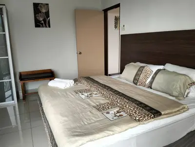 a large bed with a blanket on top of it at Marina Heights Home Suite Teluk Batik in Lumut