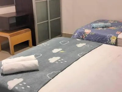 a bedroom with a bed with a blanket with hearts on it at Marina Heights Home Suite Teluk Batik in Lumut