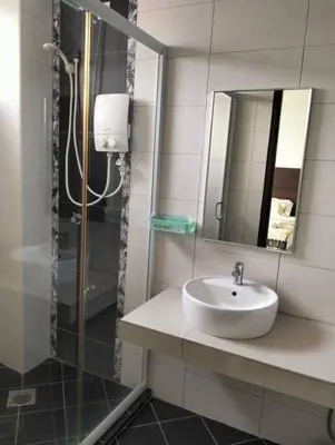 a bathroom with a sink and a shower at Marina Heights Home Suite Teluk Batik in Lumut