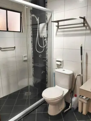 a bathroom with a toilet and a shower at Marina Heights Home Suite Teluk Batik in Lumut