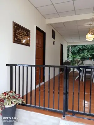 a balcony with a black railing and a table at Bilik Umar in Gerik