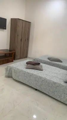 two beds sitting next to each other in a room at Bilik Umar in Gerik