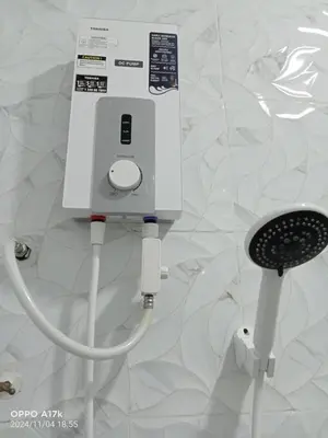a white electrical device is plugged into a wall at Bilik Umar in Gerik