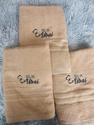 three towels with the words bilky wool on them at Bilik Ubaidillah in Gerik