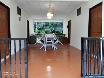 a table and chairs in the middle of a room at Bilik Ubaidillah in Gerik