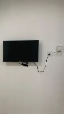 a flat screen tv hanging on a wall at Bilik Ubaidillah in Gerik