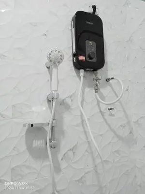 a phone and a hair dryer on a wall at Bilik Ubaidillah in Gerik
