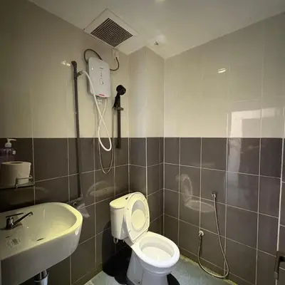 a bathroom with a shower and a toilet and a sink at Ipoh Apartment Suites in Ipoh