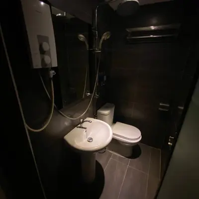 a bathroom with a toilet and a sink and a shower at Ipoh Apartment Suites in Ipoh