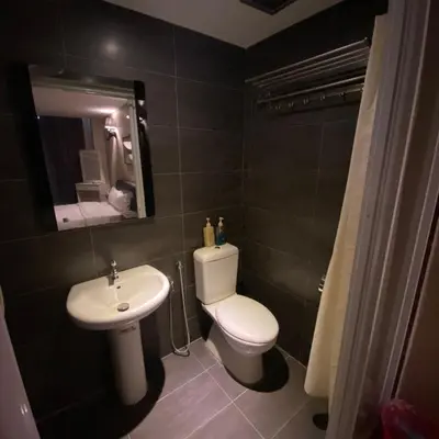 a bathroom with a white toilet and a sink at Ipoh Apartment Suites in Ipoh