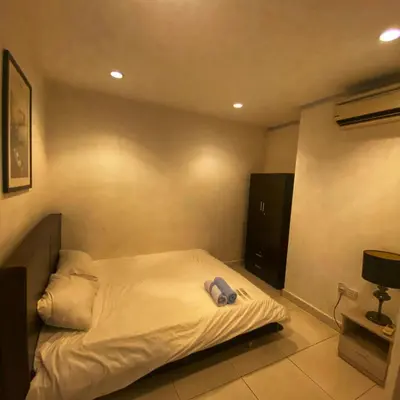 a bedroom with a bed with a hat on it at Ipoh Apartment Suites in Ipoh