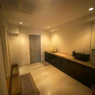 a small kitchen with a counter and a sink at Ipoh Apartment Suites in Ipoh