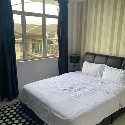 a bedroom with a large bed with a window at Ipoh Apartment Suites in Ipoh