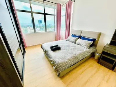 a bed in a room with a large window at 2BR LaPrimo Homestay Bandar Meru Raya Ipoh in Ipoh