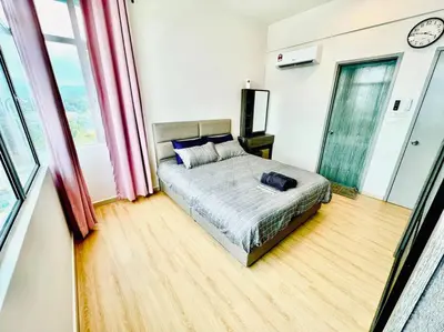 a bedroom with a bed and a clock on the wall at 2BR LaPrimo Homestay Bandar Meru Raya Ipoh in Ipoh