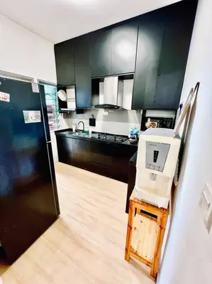 a kitchen with dark green cabinets and a refrigerator at 2BR LaPrimo Homestay Bandar Meru Raya Ipoh in Ipoh
