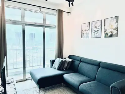 a living room with a blue couch and a large window at 2BR LaPrimo Homestay Bandar Meru Raya Ipoh in Ipoh